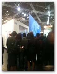 Visitors at Medica watching an exhibitor presentation  &raquo; Click to zoom ->