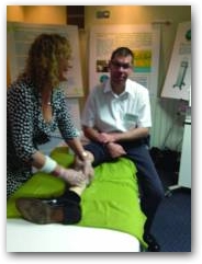 Julie Soroczyn, MD of PhysioPod UK treats Alex Munnoch who had a calf injury at the event.  &raquo; Click to zoom ->