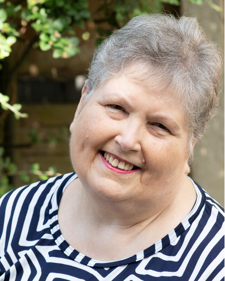 Gaynor Leech smiling in black and white striped top